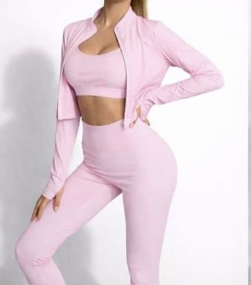 Woman in a light pink athletic outfit posing against a white background.