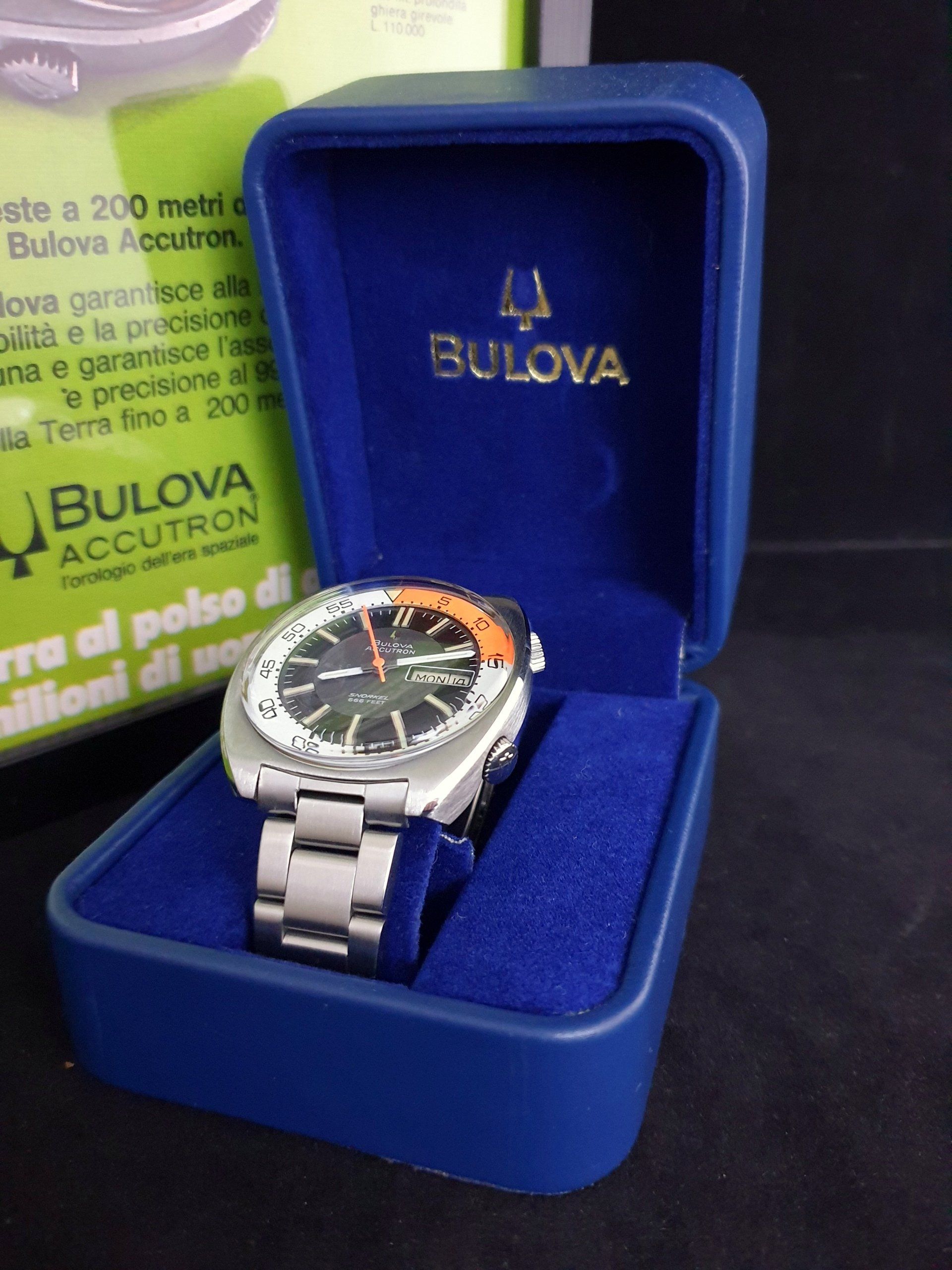 Bulova wristwatch in an open blue velvet presentation box, with a brochure in the background