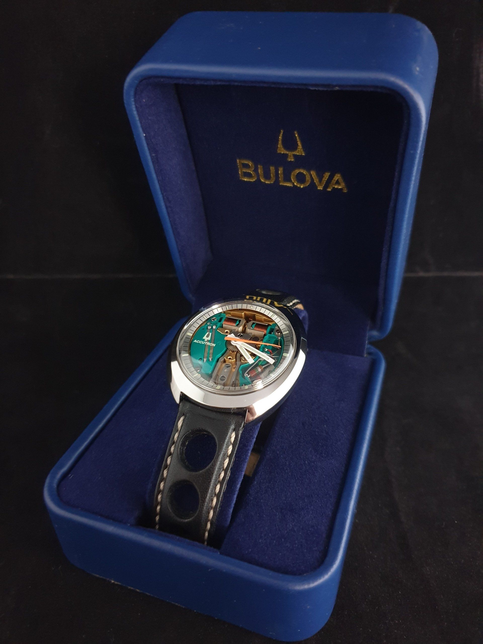 Bulova wristwatch with green dial in an open blue presentation box