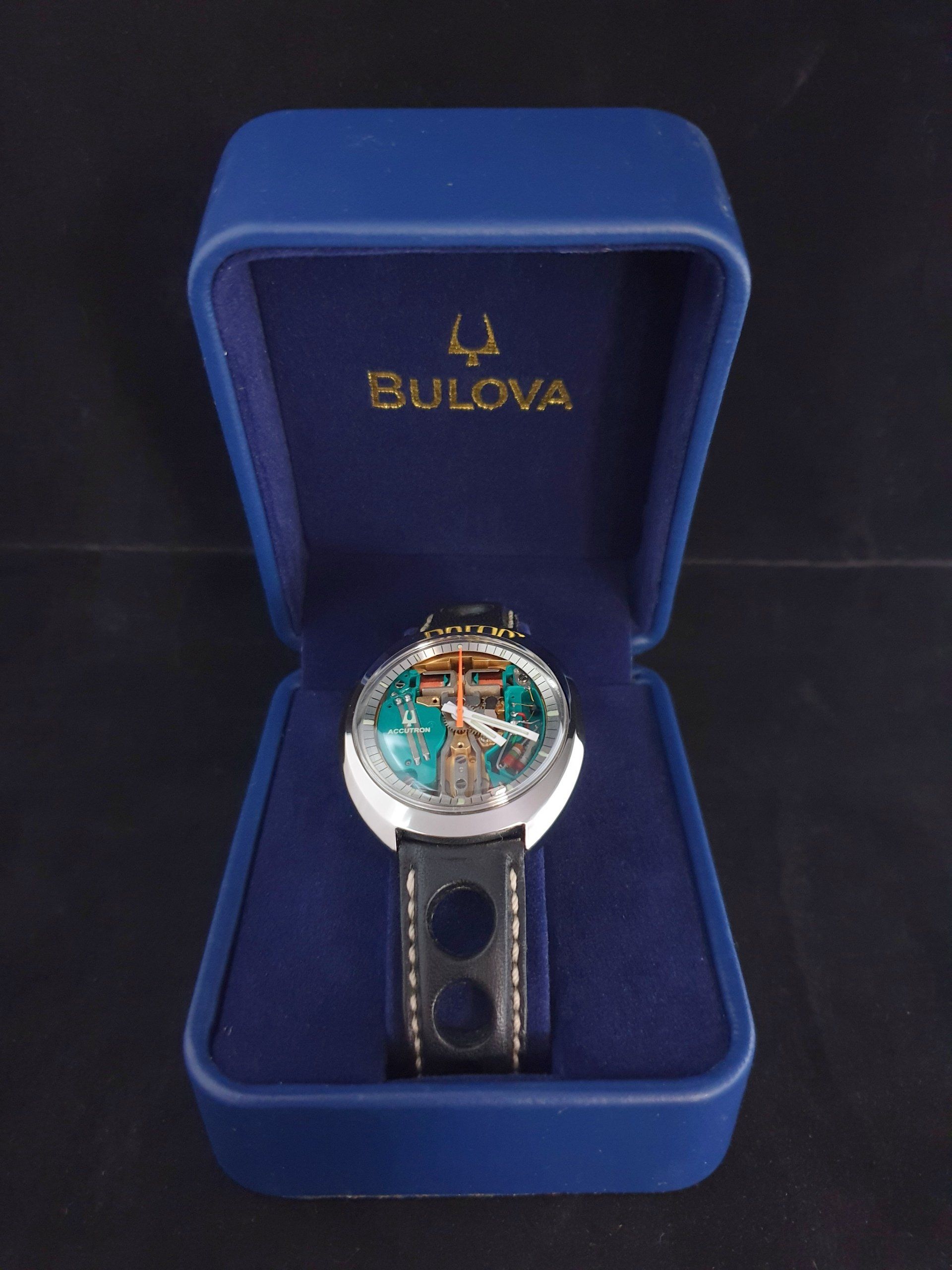 Bulova wristwatch in blue presentation box, with silver case and dark strap.