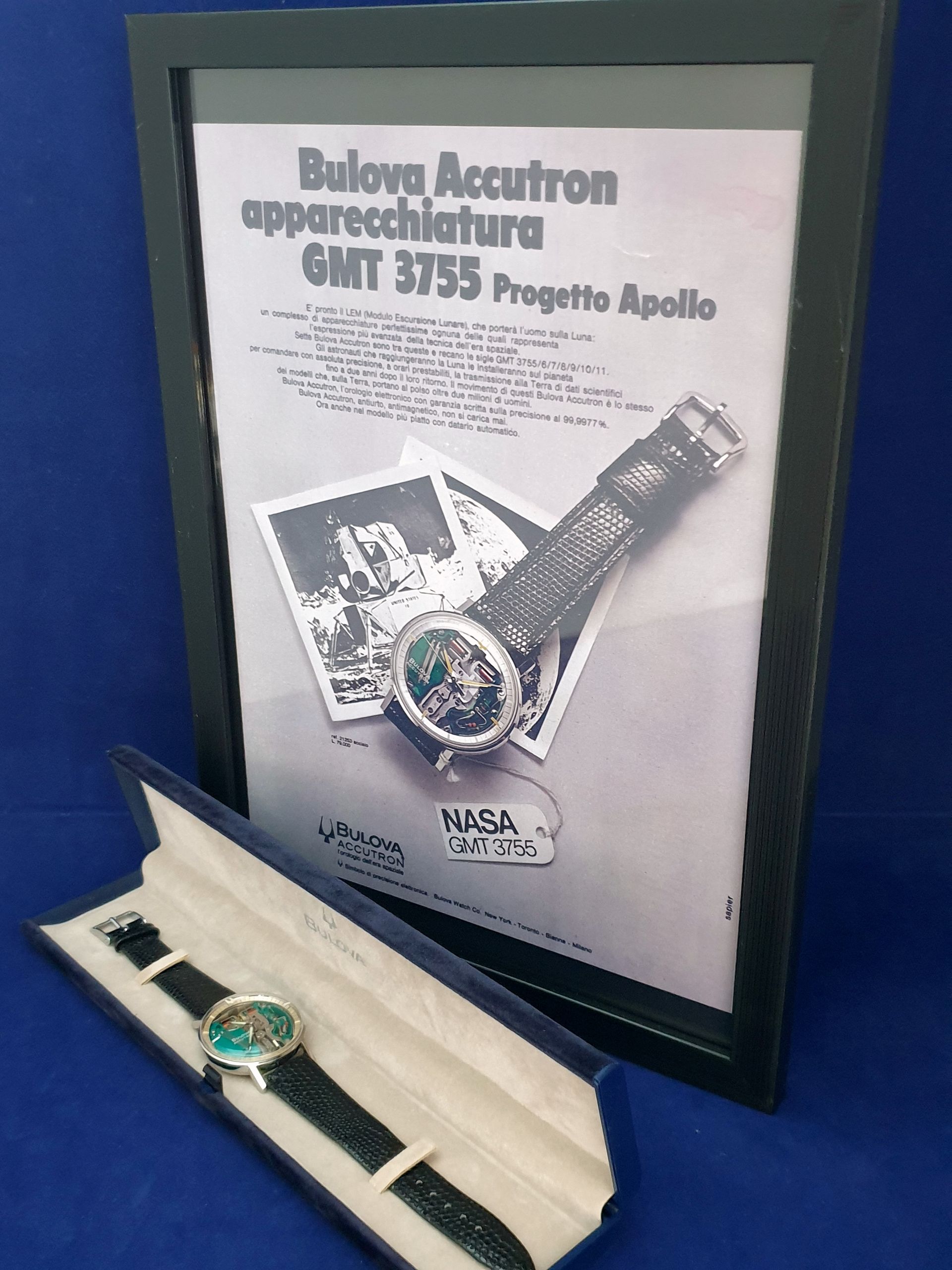 Apollo 15 GMT 3753 watch and NASA display plaque on blue background