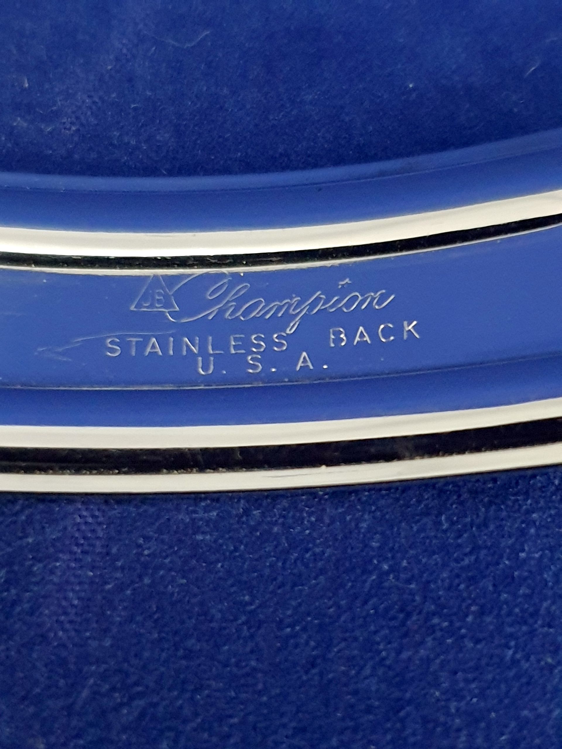 Close-up of a blue vintage Thermo stainless steel item with silver trim and logo text.