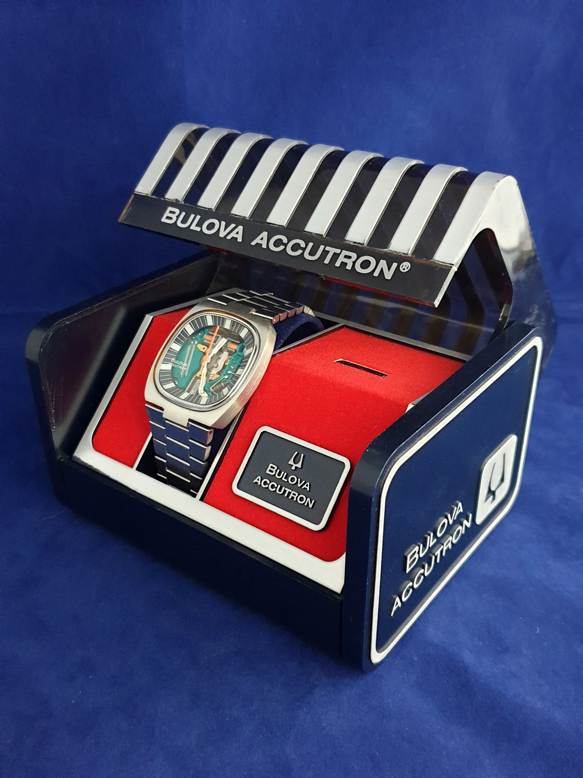 Bulova Accutron watch displayed in a red-and-blue retail box with striped lid