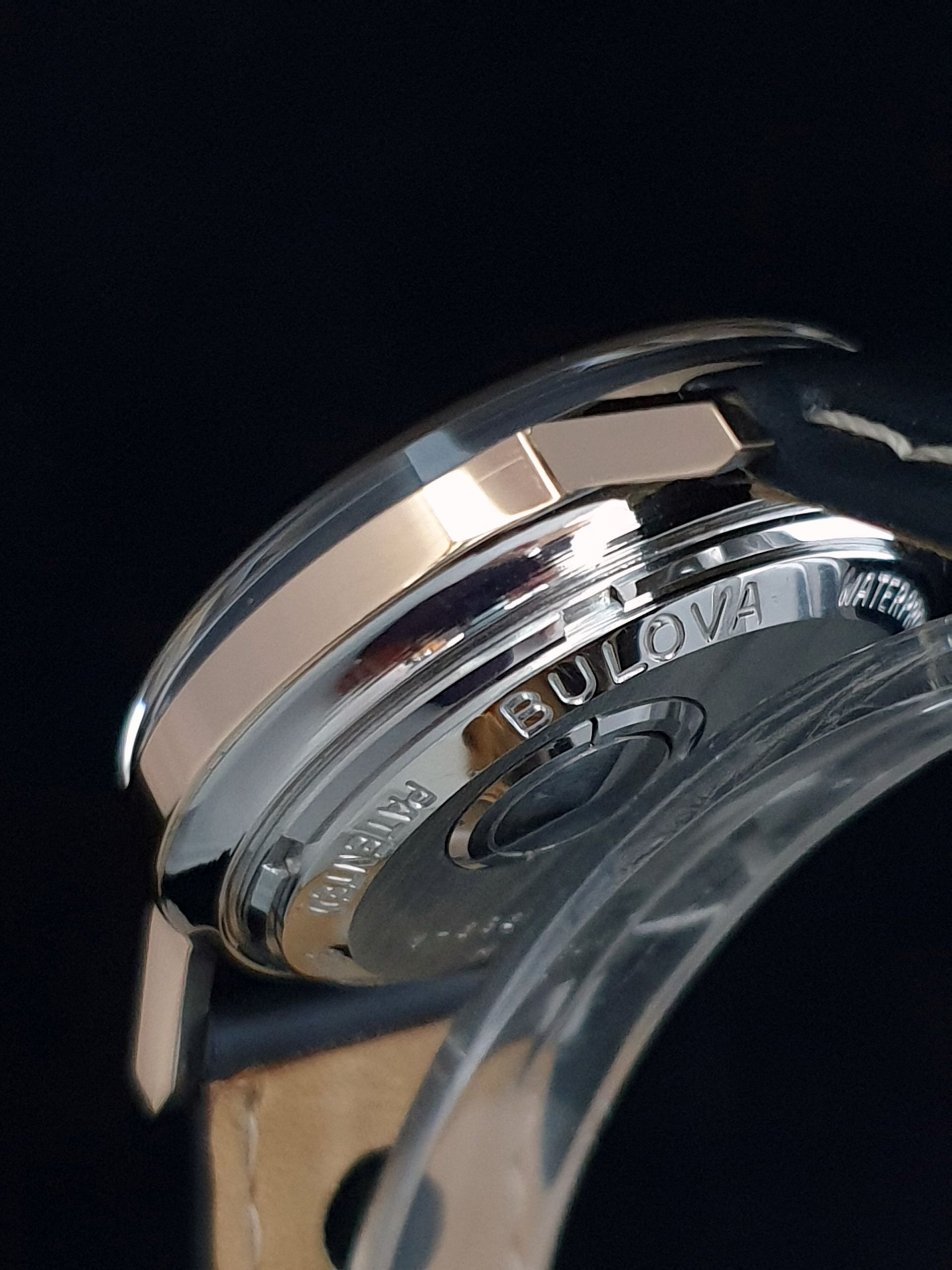 Close-up of a Bulova wristwatch back with polished silver case and crystal face