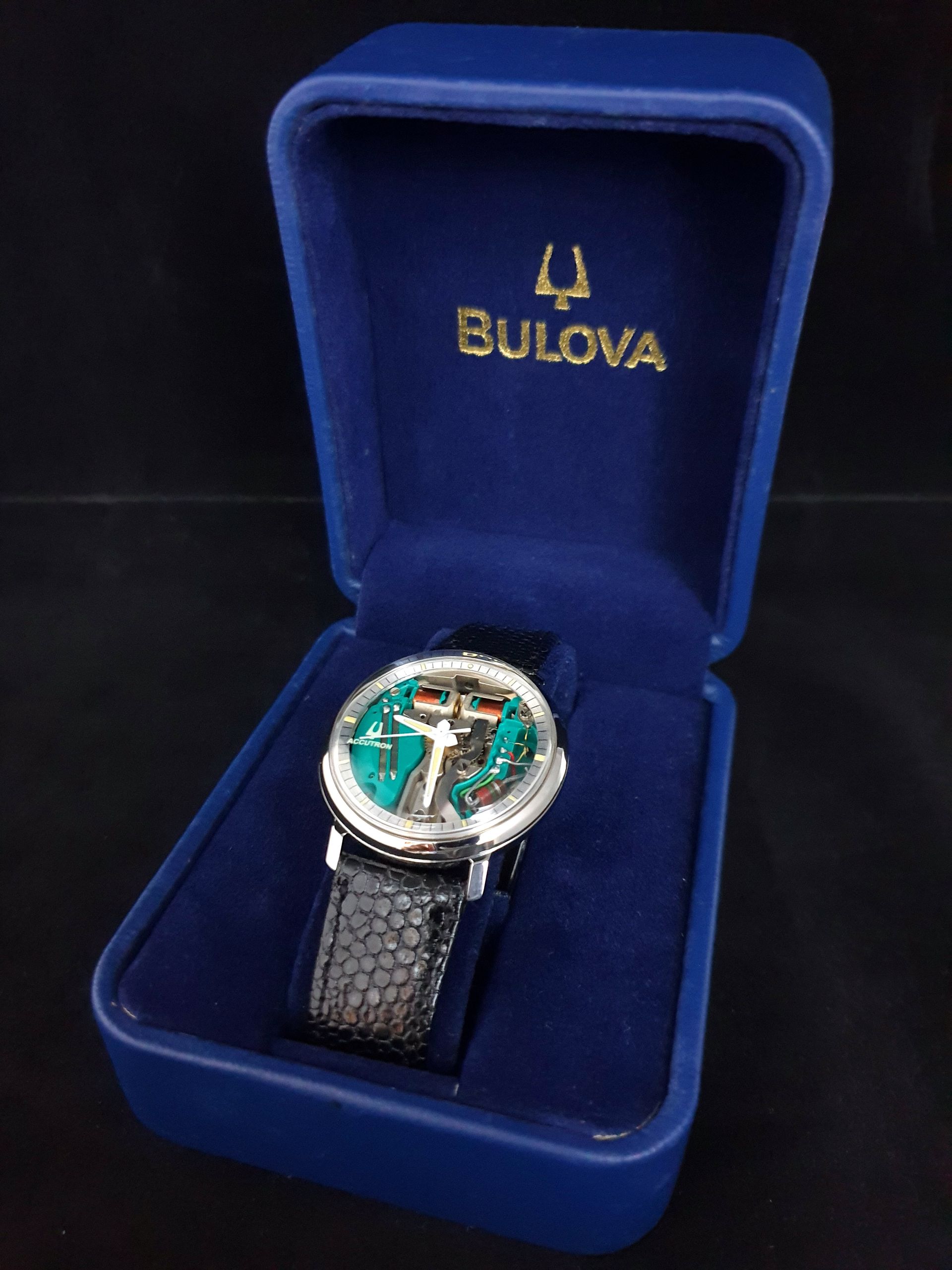Bulova wristwatch with blue strap in a blue velvet presentation box