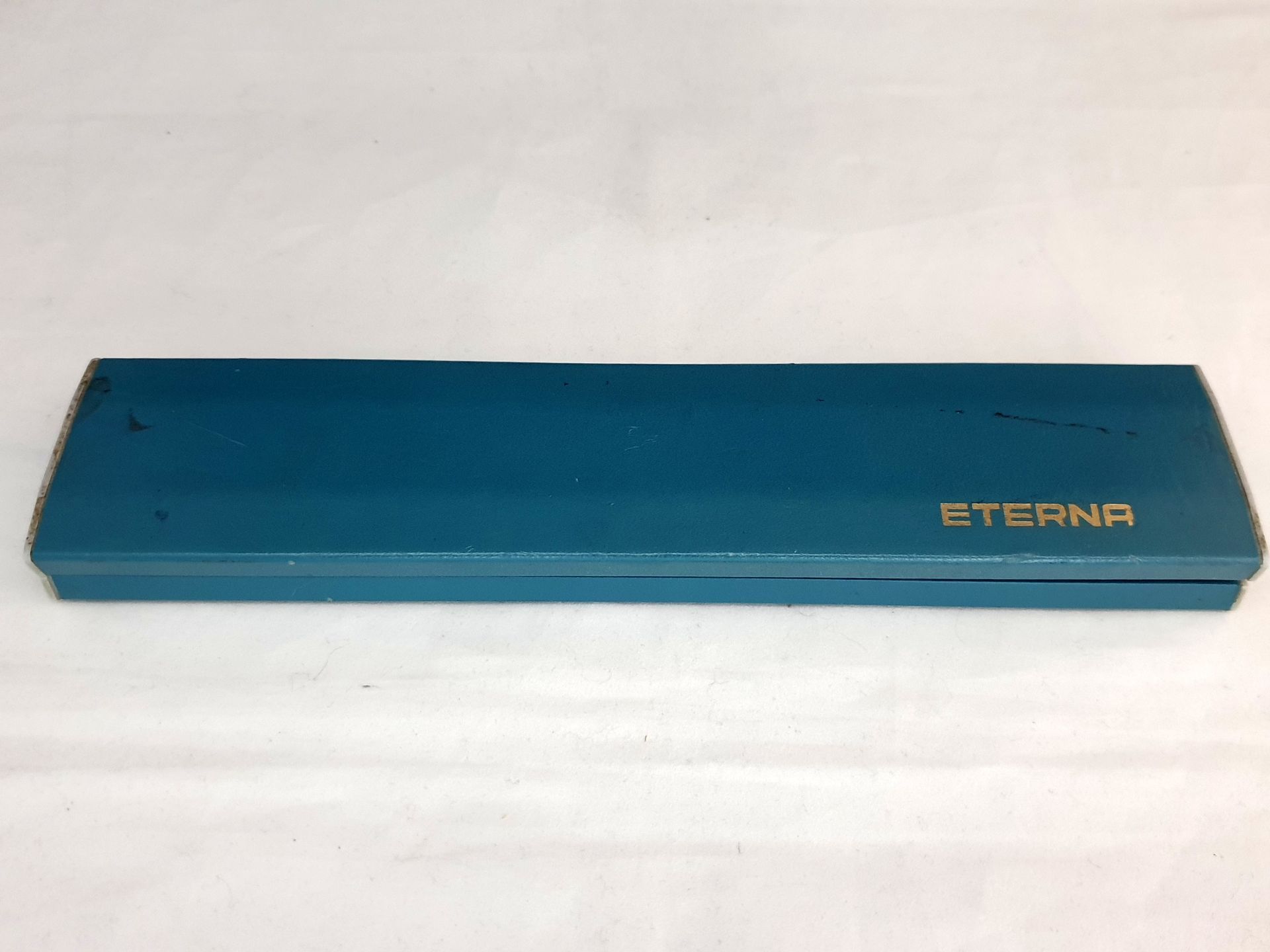 Blue rectangular ETERNA pencil case on a white background