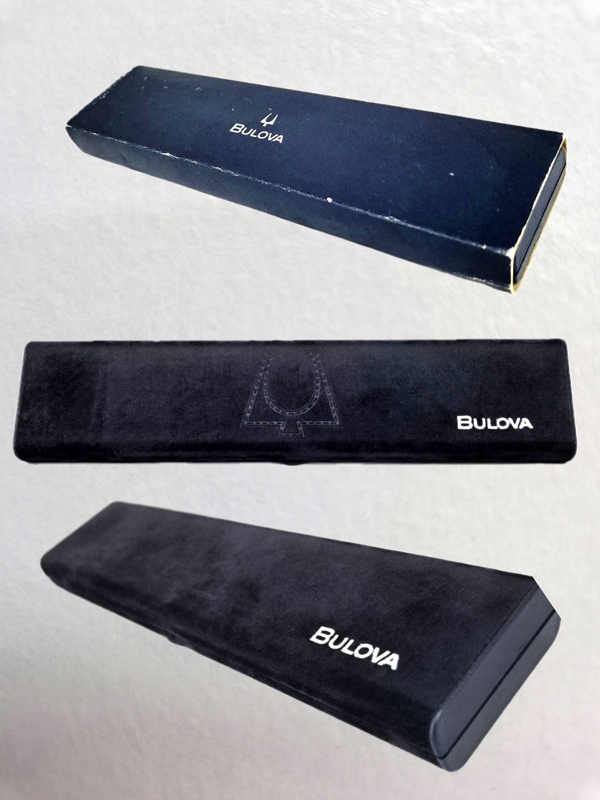 Three navy Bulova watch boxes and pouches displayed on a white background.