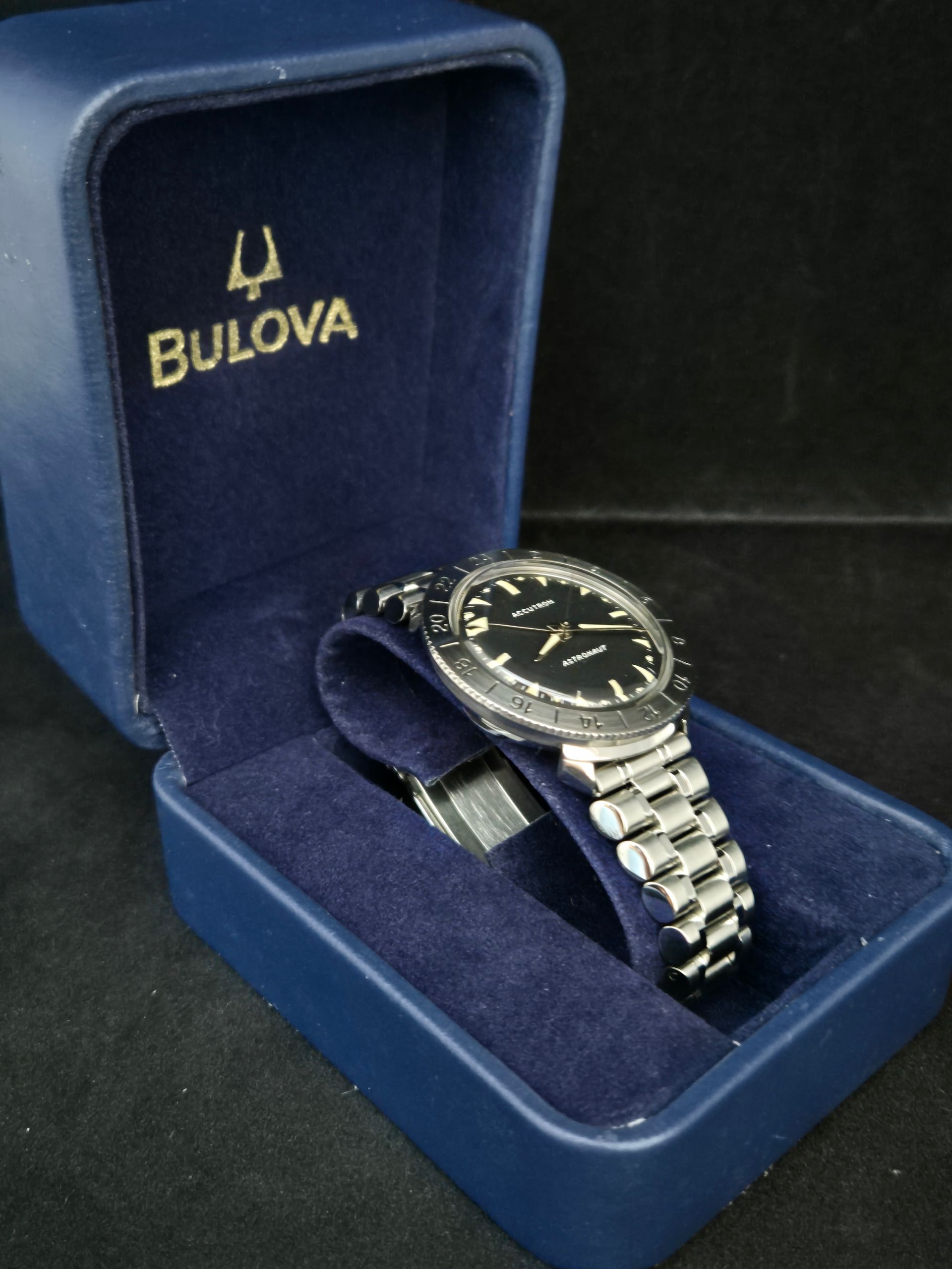 Bulova wristwatch in a blue presentation box with logo on the lid