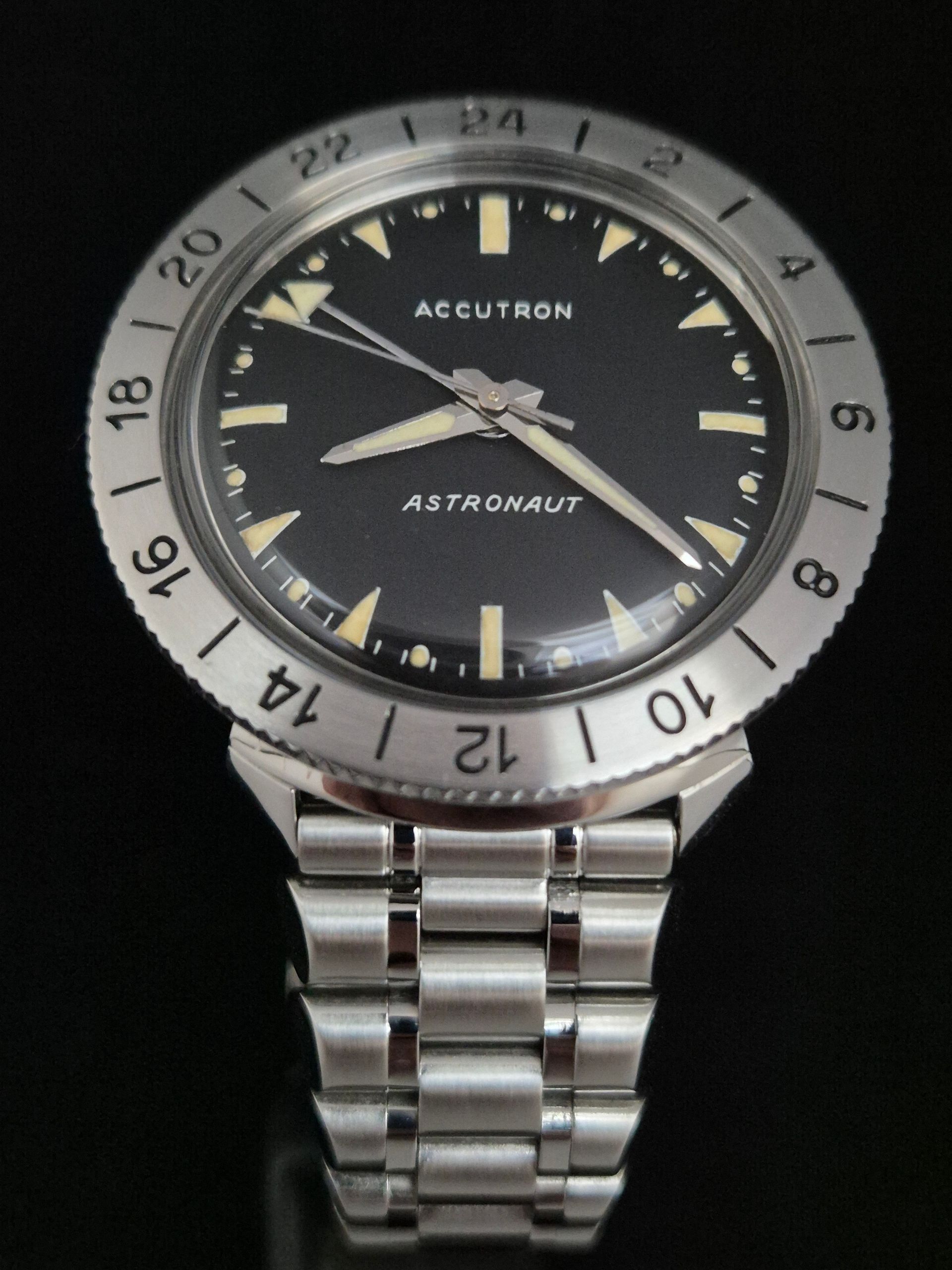Silver Accutron Astronaut wristwatch with black dial and rotating bezel on metal band
