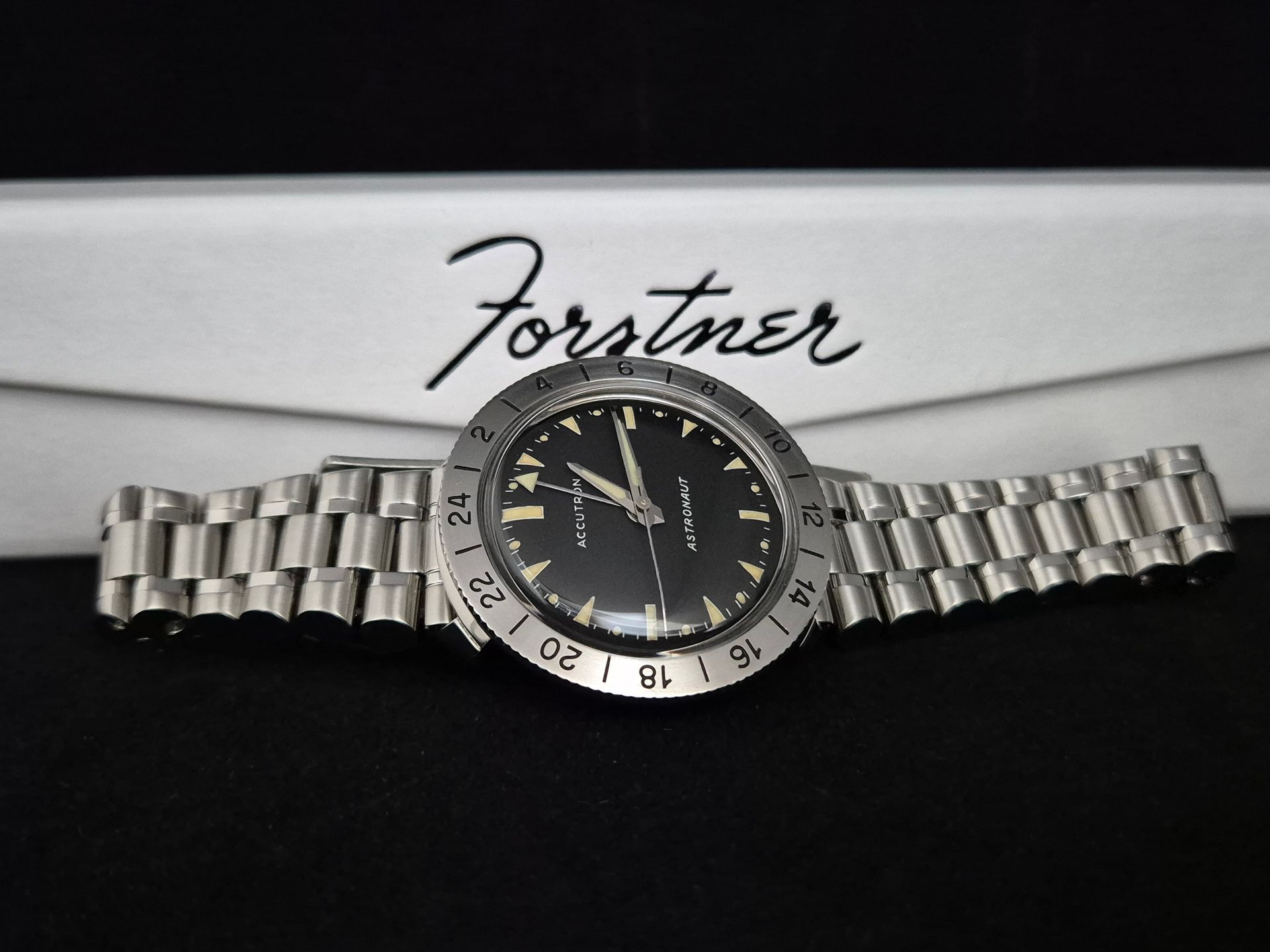 Fortimer wristwatch with silver metal band on a branded box