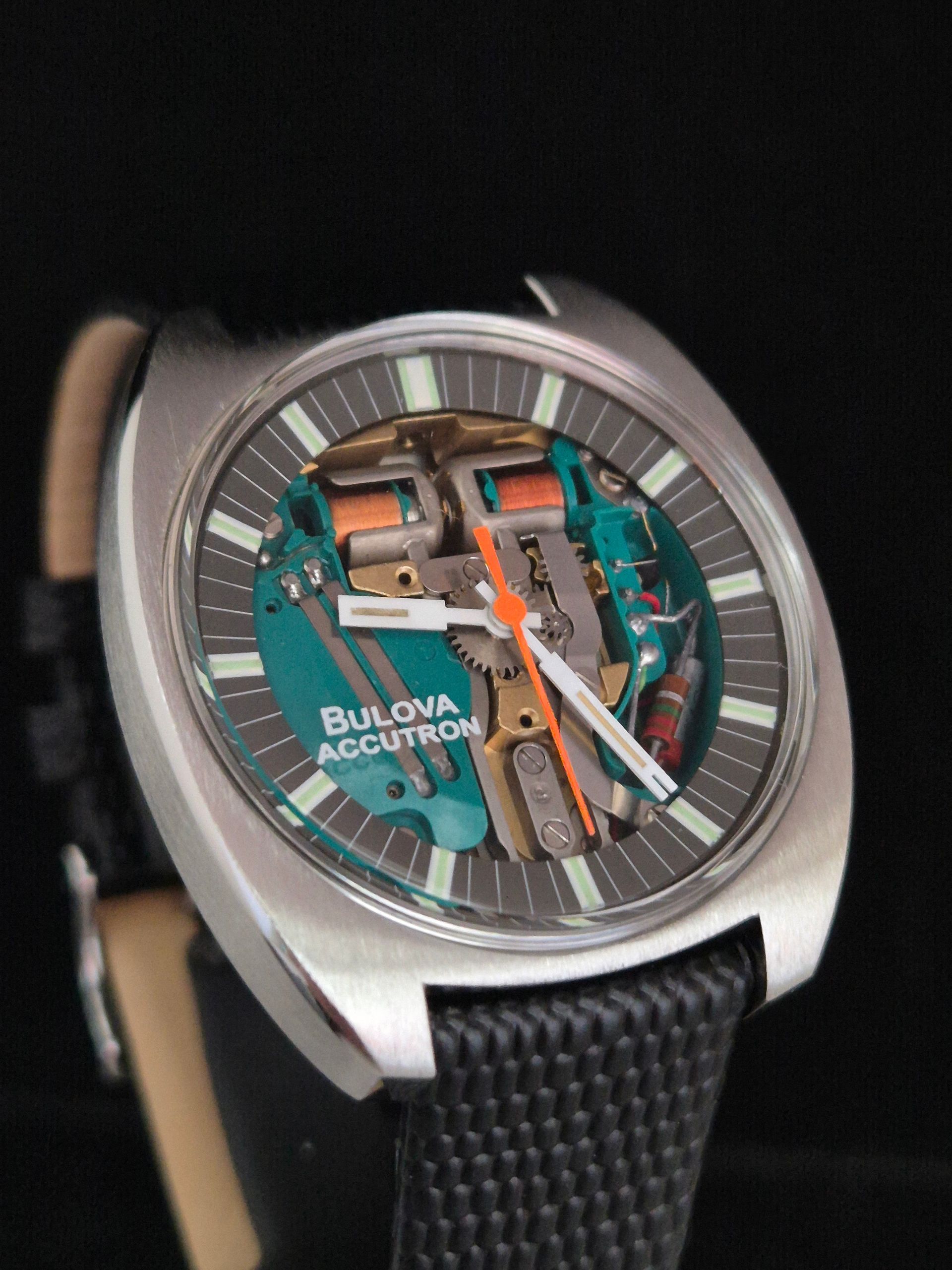 Bulova Accutron watch with exposed mechanical dial, silver case, black strap