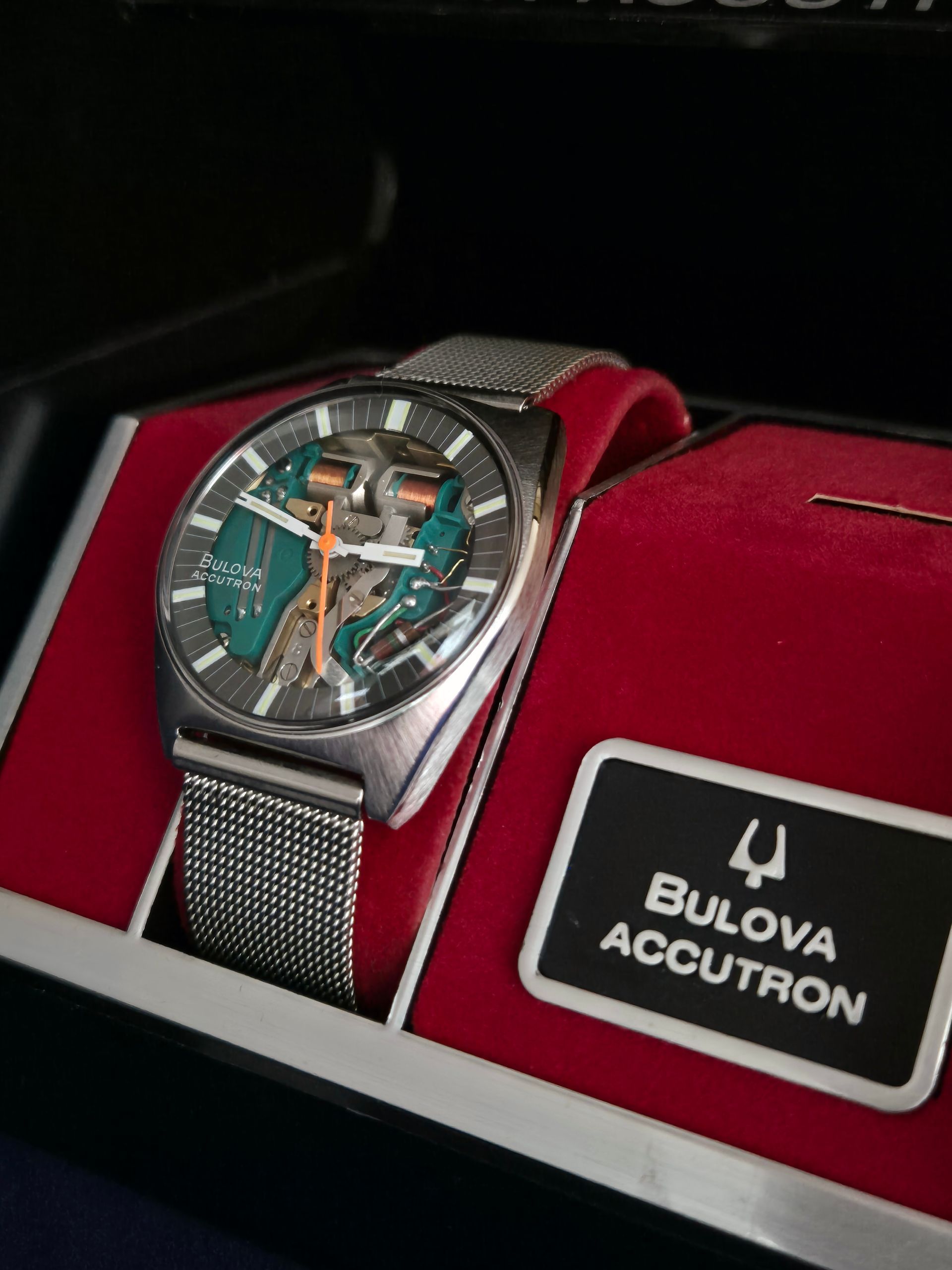 Bulova Accutron watch with teal dial in a red presentation box