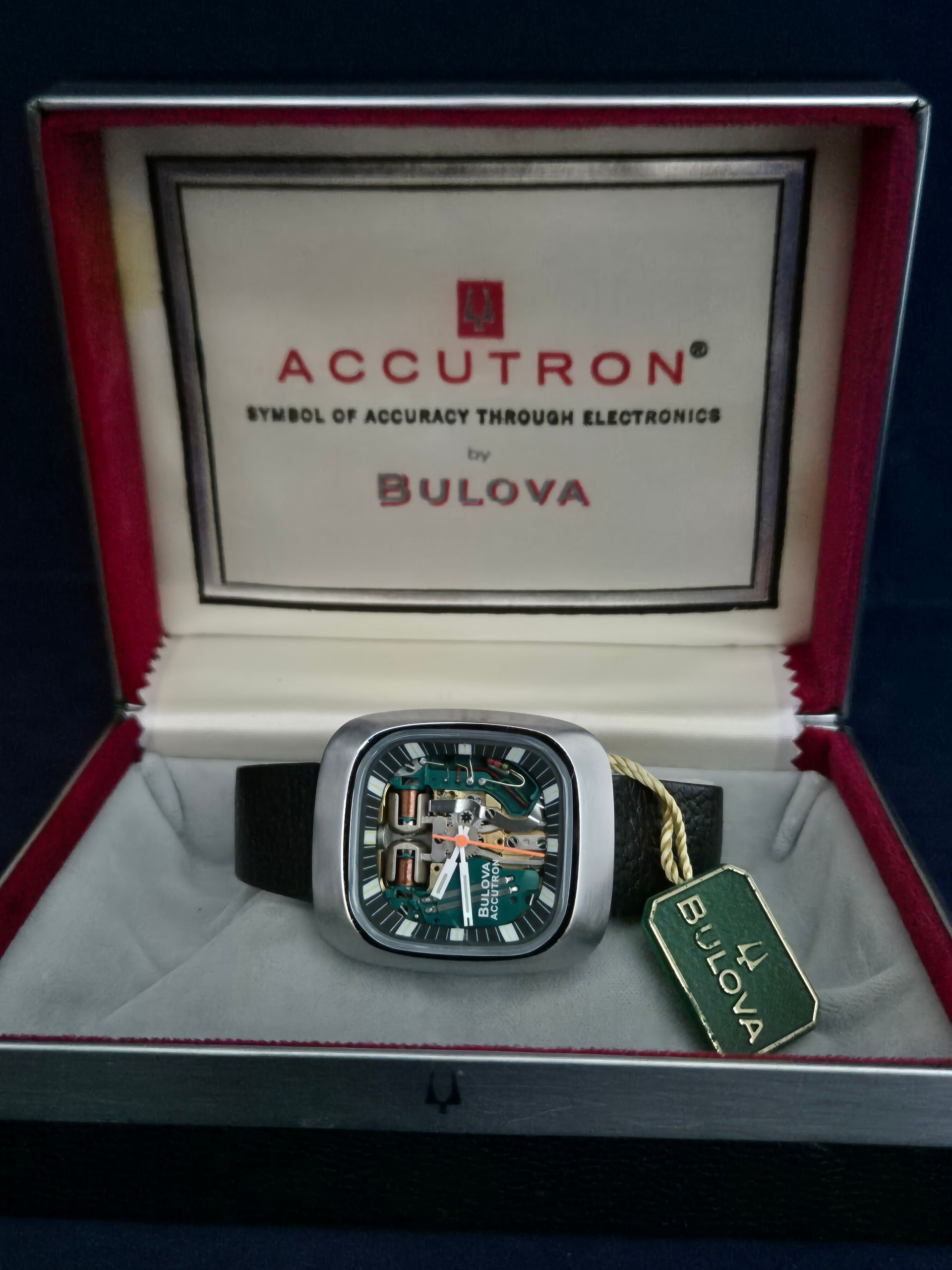 Bulova Accutron watch in red display box with green tag and case insert