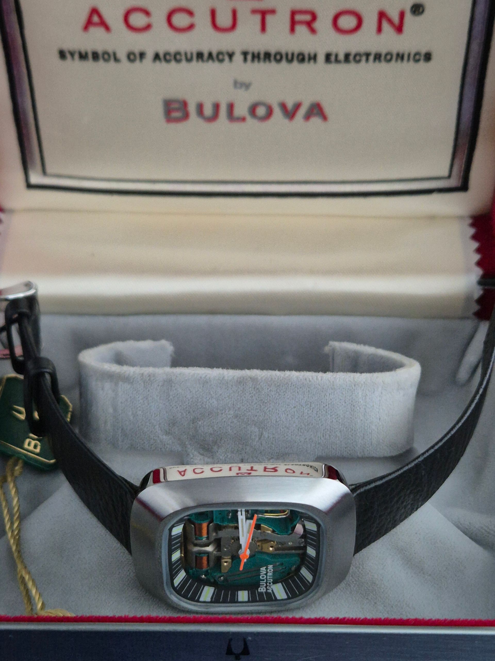 Bulova Accutron watch in a presentation box, with black strap and visible dial details