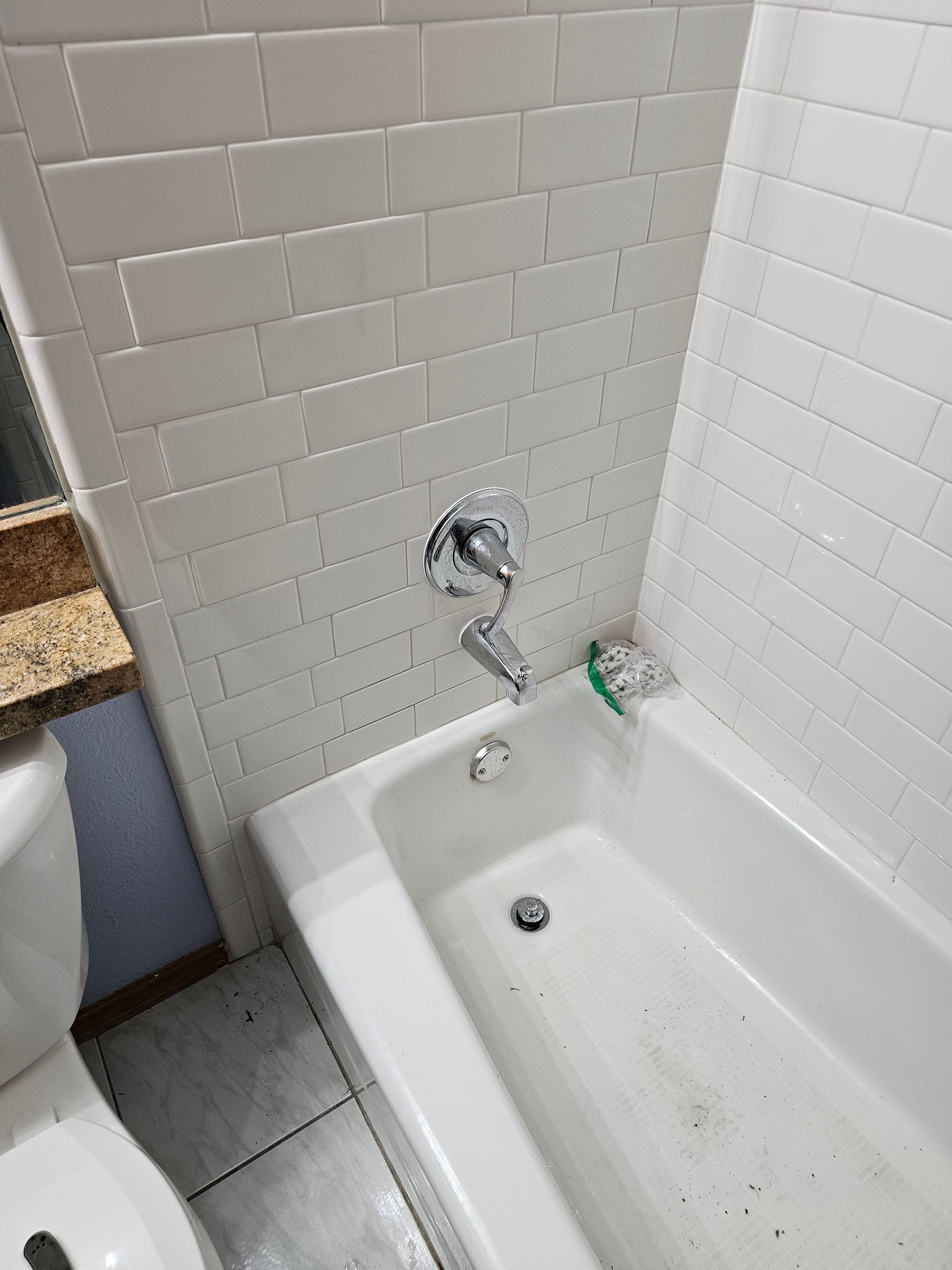 there is a bathtub in the bathroom next to a toilet