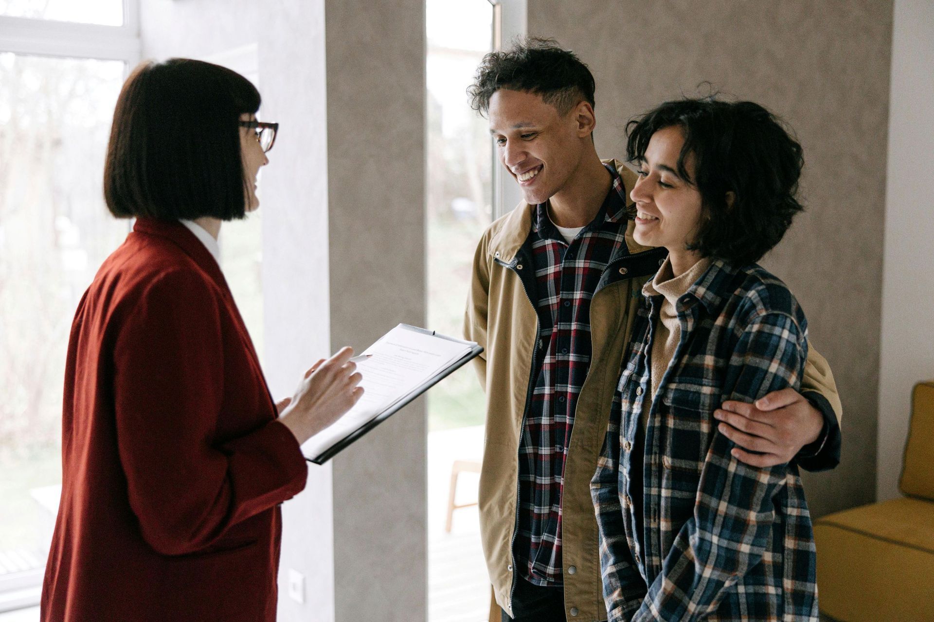 A couple talking to a real estate agent.