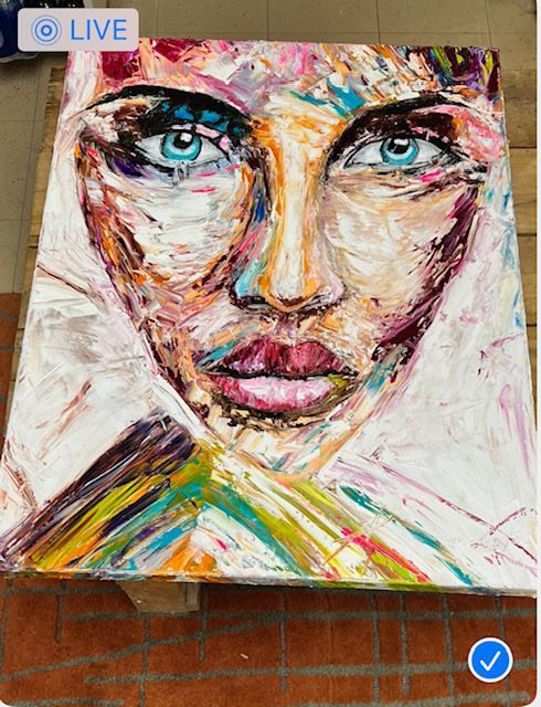 A painting of a woman 's face is live on facebook