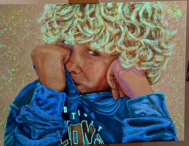 A glow in the dark painting of a boy with curly hair