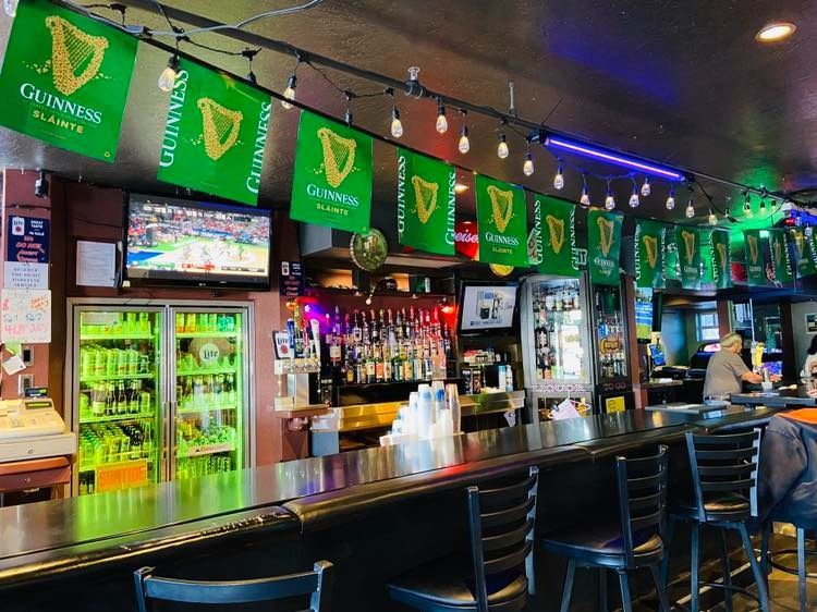 A bar with guinness flags hanging from the ceiling