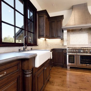 A kitchen with stainless steel appliances and wooden cabinets
