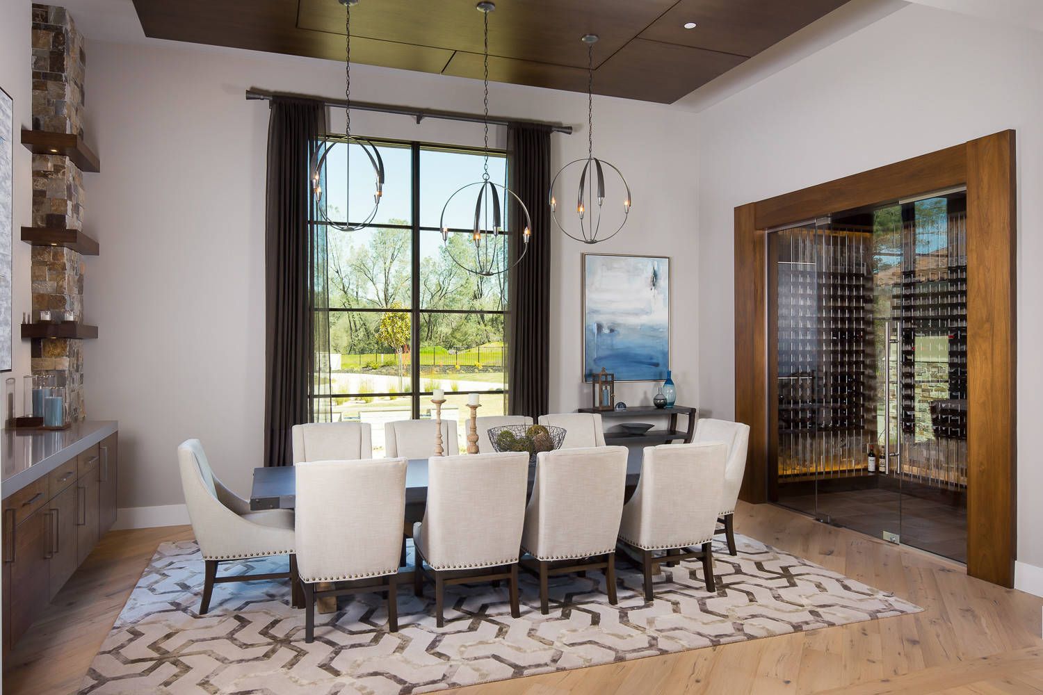 A dining room with a table and chairs and a wine cellar.
