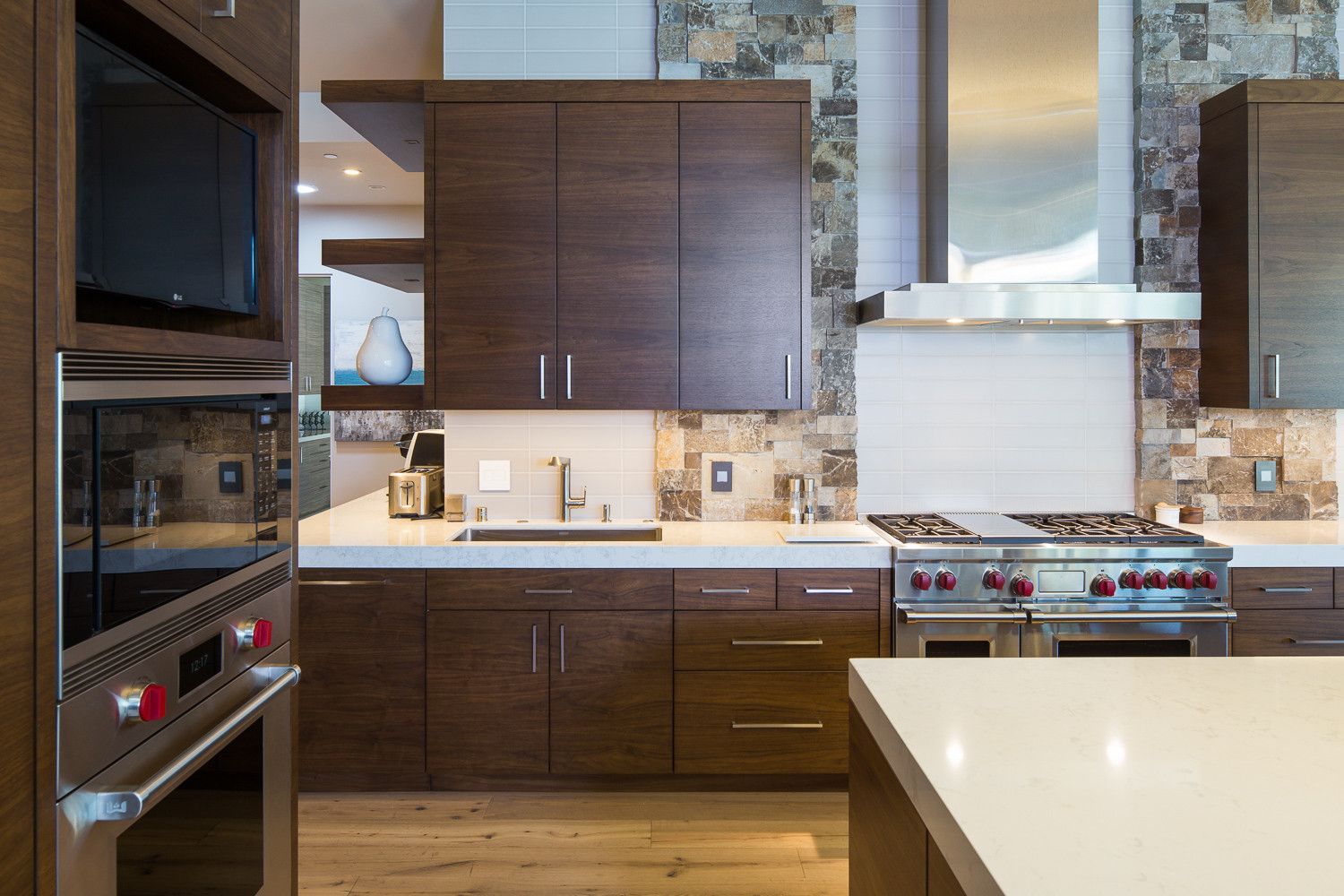 A kitchen with stainless steel appliances and wooden cabinets