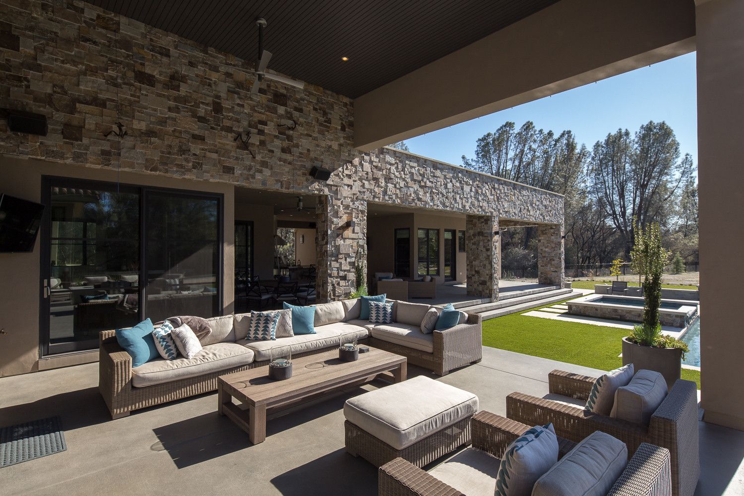 A large patio with a couch , chairs and a table