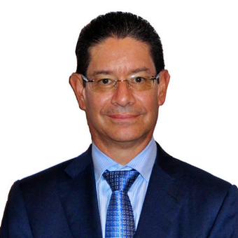 A man in a suit and tie is smiling for the camera