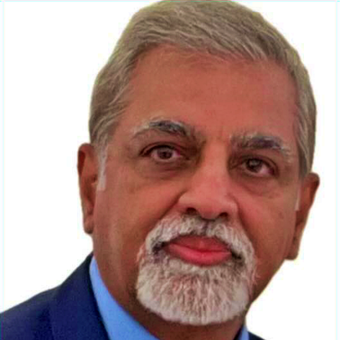 A man with a beard is wearing a suit and tie.