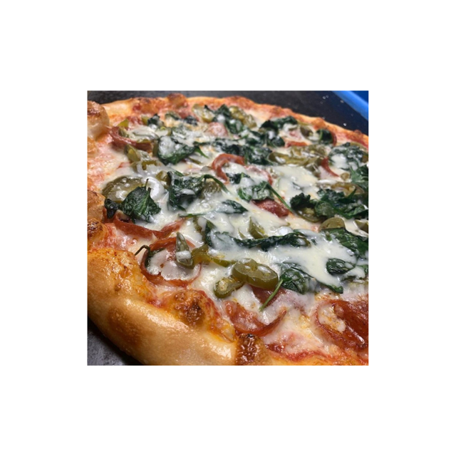 Pizza with spinach, jalapeños, tomatoes, and cheese. Close-up shot on a table.