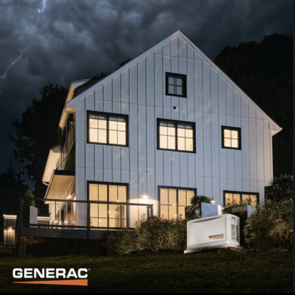 White house at night with lights on and a Generac generator in the yard under stormy skies