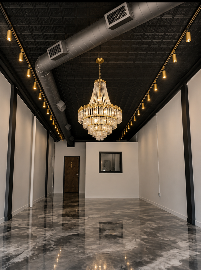 Elegant hallway with a chandelier, glossy marble floor, and white walls under a black ceiling