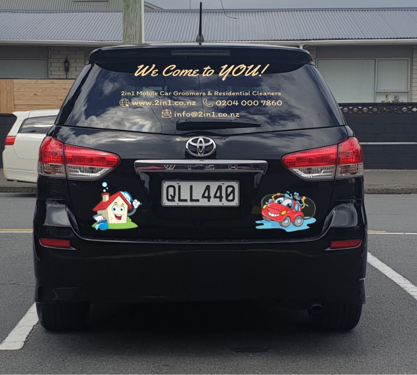 A black car with a welcome to you sticker on the back window