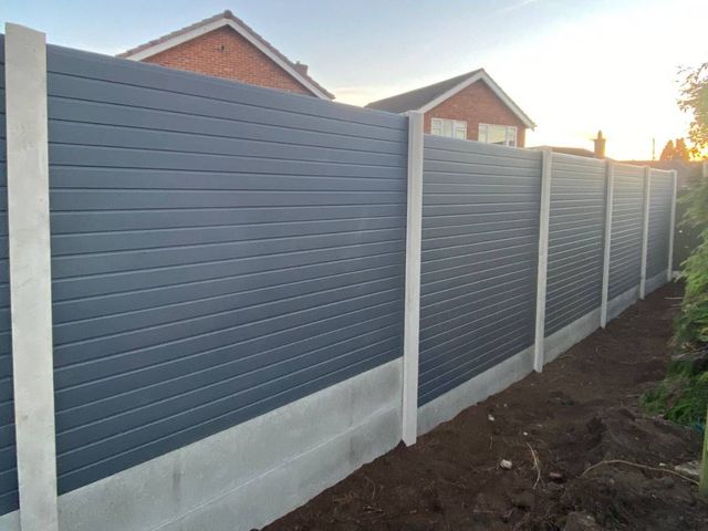 Anthracite grey composite fence panels between concrete posts with gravel boards along a Wollaton boundary