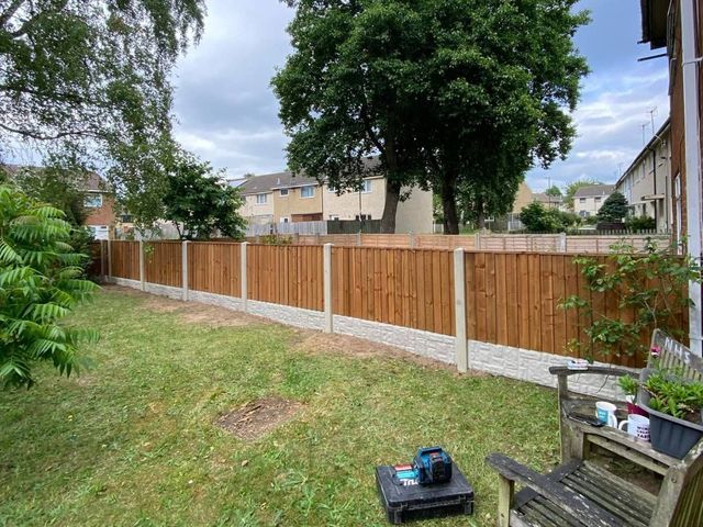 A new closeboard fence on concrete posts and gravel boards around a lawn in Kimberley with open views behind