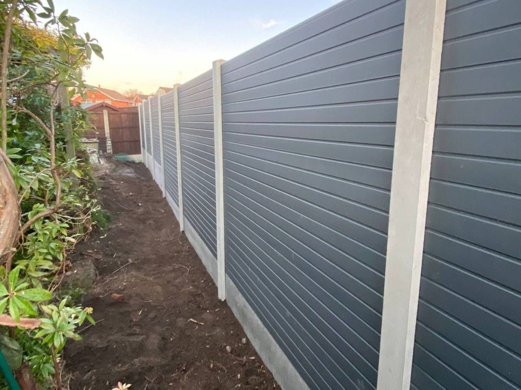 Anthracite grey composite fence panels between concrete posts and gravel boards in a Gamston garden