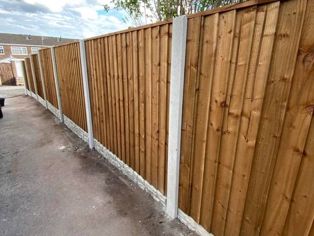 A completed run of closeboard fence panels on concrete posts and gravel boards along a Keyworth walkway