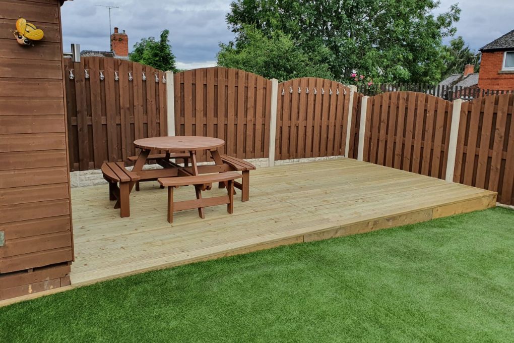 A completed timber garden deck in West Bridgford with garden furniture in place