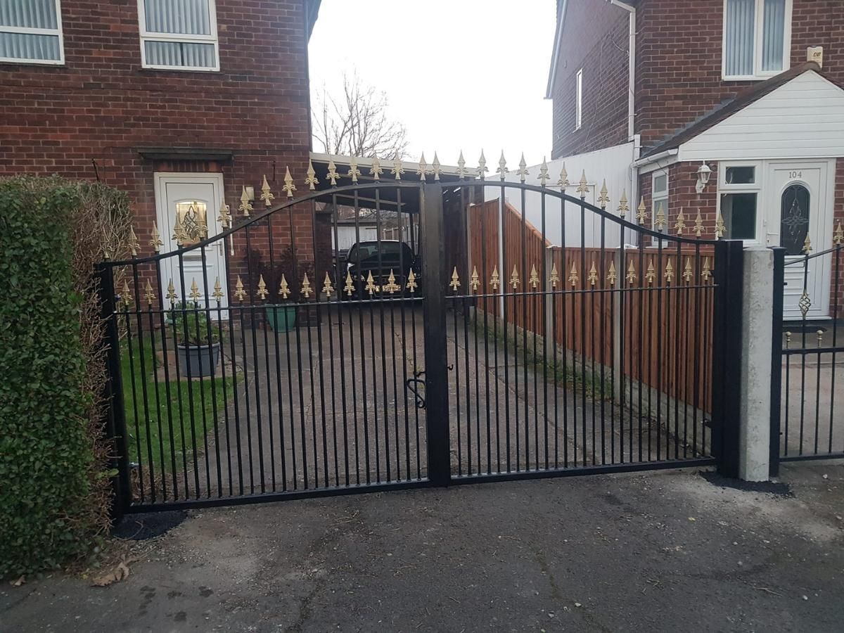 Nottingham Fencing Black arched double driveway gates with gold spear tops on top rail and interim bars
