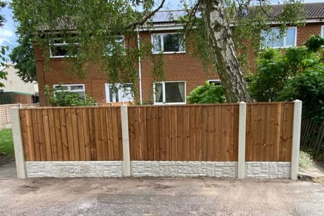 A new low timber front garden fence on concrete posts and gravel boards outside houses in Top Valley