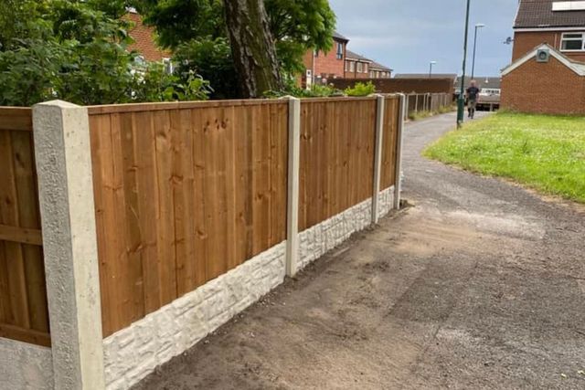 A new closeboard fence on concrete posts running alongside a pedestrian path in Top Valley