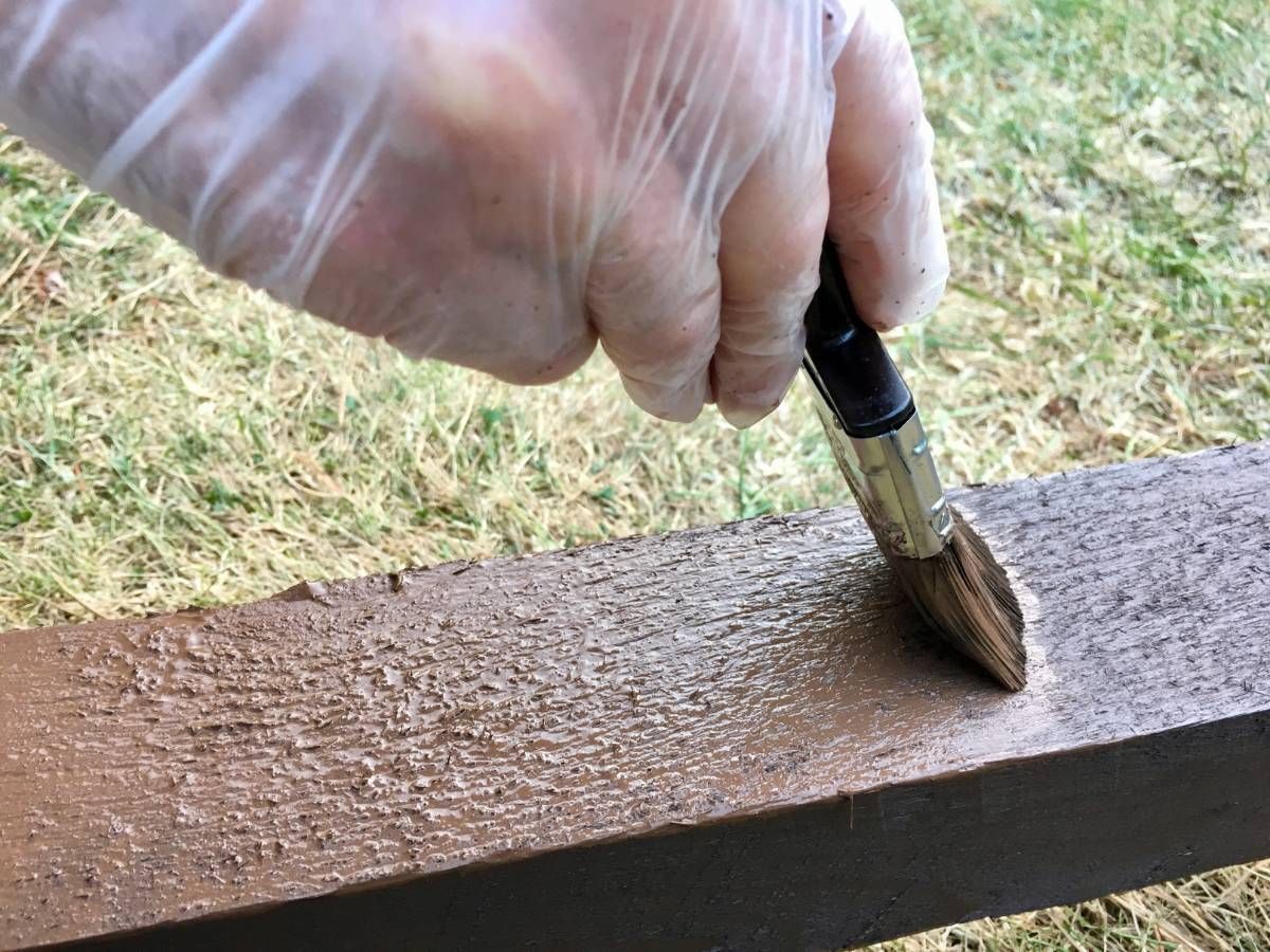 Nottingham Fencing painting a wooden fence post