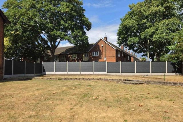 A completed run of anthracite grey composite fencing along a rear garden boundary in Sutton-in-Ashfield