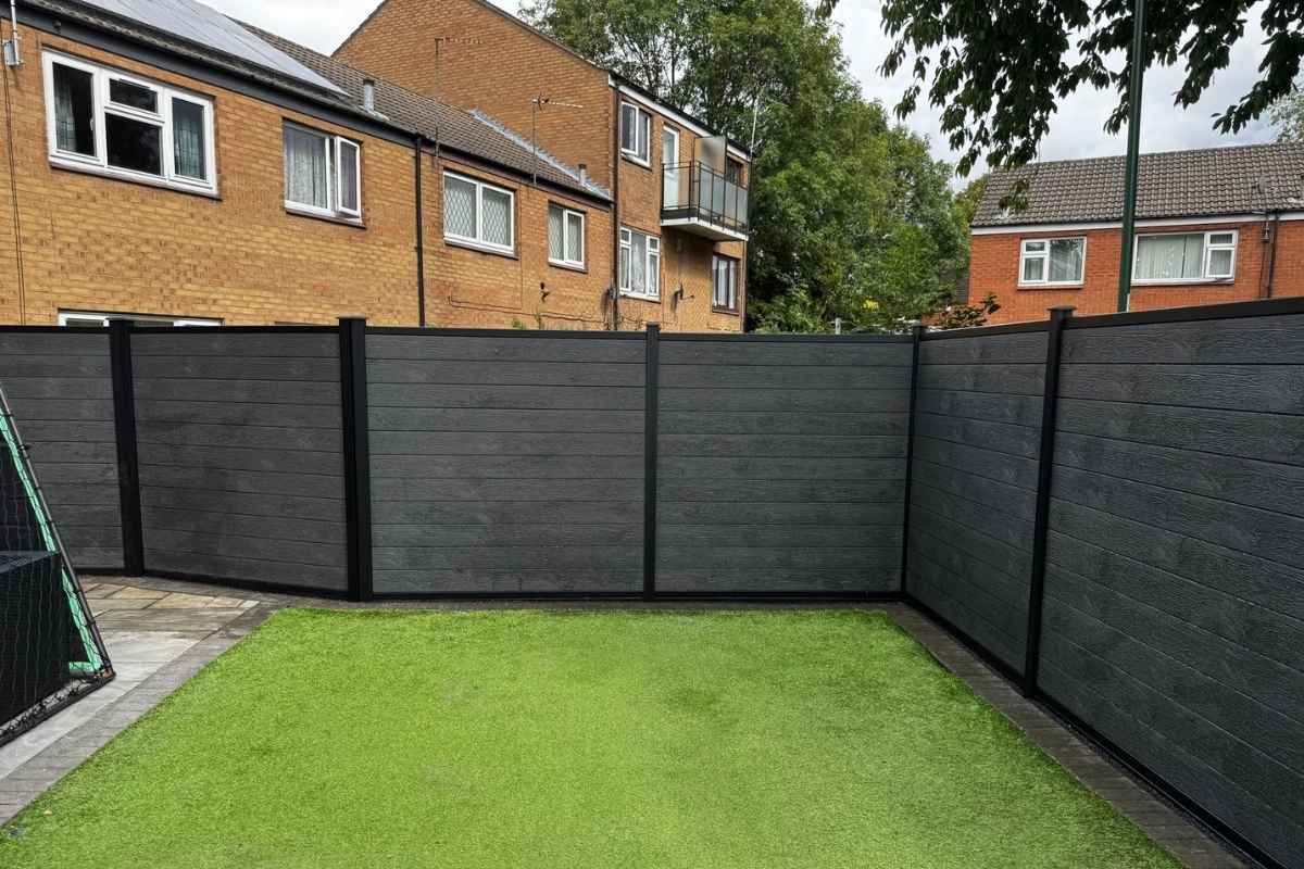 Anthracite grey composite fencing in black metal posts enclosing a rear garden, installed by Nottingham Fencing