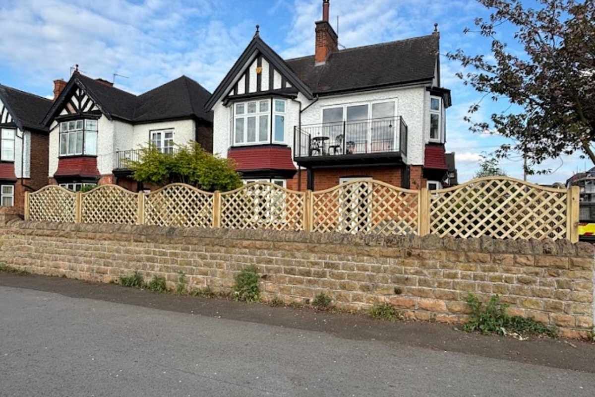 Arched top trellis panels fitted along a stone front garden wall in West Bridgford
