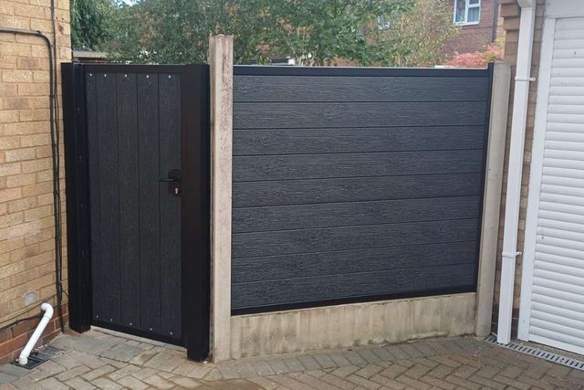 Black composite fencing and a matching composite gate in a metal frame in Long Eaton