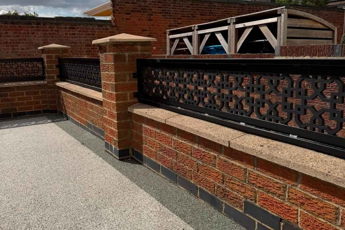 Cathedral trellis wall toppers and brick piers alongside a resin bound driveway in Long Eaton