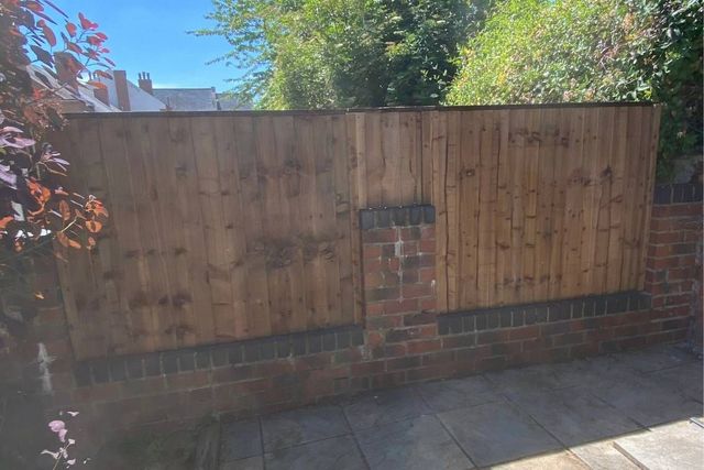Closeboard fence panels fitted above an existing brick wall and pier in Hucknall