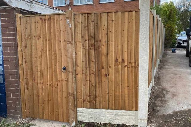 Closeboard fencing and a timber side gate along a shared driveway in Arnold