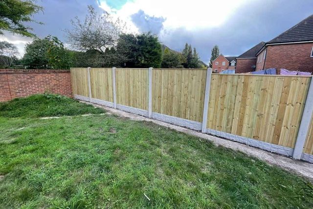 Featheredge fence panels fitted into concrete posts with rock-faced gravel boards along a garden boundary